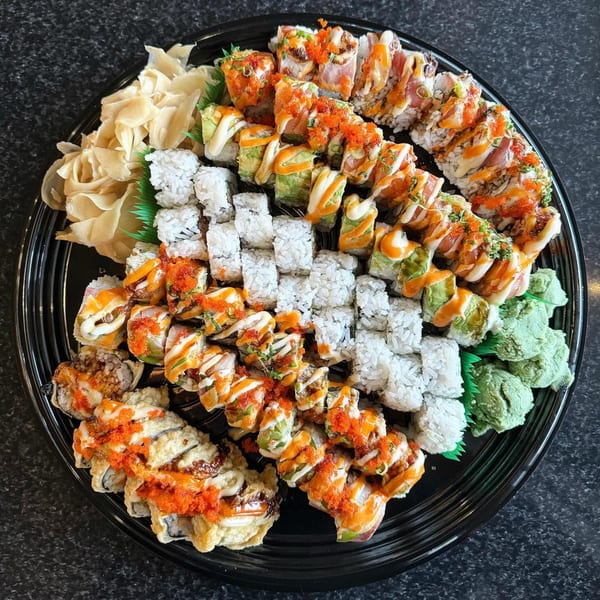 Large platter of Banzai Sushi's various sushi rolls, including California, spicy tuna, and tempura rolls.